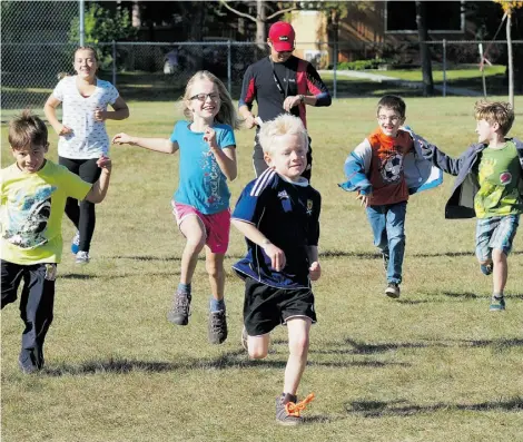  ?? Larry Wong/Edmonton Journal ?? Children play games at a family barbecue held at Windsor Park Community League Hall.