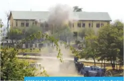  ??  ?? SRINAGAR: Smoke and dust rises from an Indian Border Security Force (BSF) building that was held by suspected militants, after it was hit by explosives fired by government forces in Srinagar yesterday. —AFP