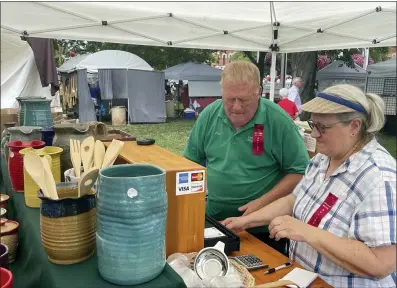  ?? PHOTOS BY MARAH MORRISON — THE NEWS-HERALD ?? Jim and Betsy Anderson, of Farmhouse Stoneware, have been attending the Chardon Square Arts Festival on the historic Chardon Square since its inception 40 years ago.