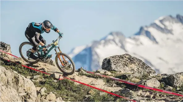  ??  ?? A racer crests the Top of the World trail in Whistler Mountain Bike Park. The B.C. Supreme Court has ruled that the waiver release Blake Jamieson signed before biking in Whistler in 2009 prevents him from suing over an accident that left him in a...