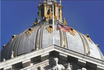  ?? Michael Macor / The Chronicle ?? The flag flies at half-staff at San Francisco City Hall following the death of Mayor Ed Lee. His body will lie in state there Friday, with a memorial service for him there Sunday.