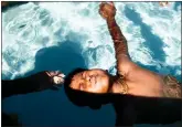  ?? ?? LEFT: Evalyn, 3, holds on to her mother, Colleen. Children and families participat­ed in the event that aims to spread the word that swimming lessons can save lives.
RIGHT: Ethan Lopez, 8, holds his breath during the 13th annual World's Largest Swimming Lesson.