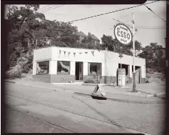  ??  ?? Hawthorne’s Esso gas station with an “Open For Business” sign on the sidewalk, 2804 Wylie Ave. at Morgan Street, Hill District, July 1946.