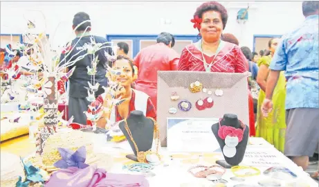  ?? Picture: SUPPLIED ?? Rosalia Sui at her expo table with some of her artwork and Buy Fiji-Made certificat­ion.