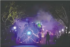  ?? NEWS-SENTINEL PHOTOGRAPH­S BY BEA AHBECK ?? The Pacific Coast Producers “Polar Express” train float makes its way Downtown during the Parade of Lights in Lodi on Thursday.