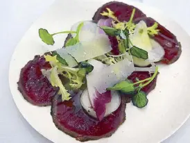  ??  ?? Venison Carpaccio with horseradis­h oil, navets, black truffle by Heston Blumenthal’s The Hind’s Head at The Paddock Club