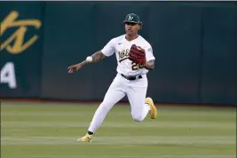  ?? RAY CHAVEZ — BAY AREA NEWS GROUP ?? The Oakland Athletics' Cristian Pache (20) fields a grounder on an RBI single by the Chicago White Sox' Elvis Andrus in the second inning at the Coliseum in Oakland on Sept. 8, 2022.