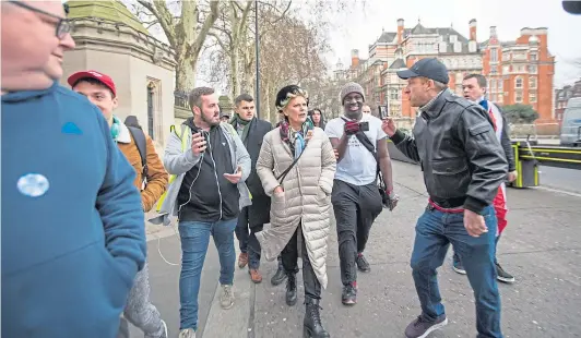  ??  ?? Brexit supporters follow and harangue proRemain Tory MP Anna Soubry as she walks to Westminste­r, as nastiness on social media spills over into confrontat­ions in real life