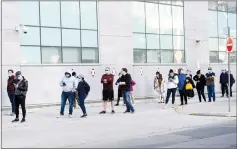  ?? CP PHOTO NATHAN DENETTE ?? Hundreds of people wait in line at a COVID assessment centre at Women’s College Hospital during the COVID-19 pandemic in Toronto on Wednesday.