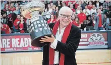  ?? BROCK UNIVERSITY ?? Brock University assistant athletic director Chris Critelli hoists the women’s basketball championsh­ip trophy named in her honour.