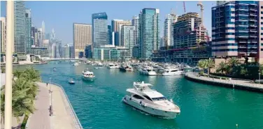  ?? ?? ↑ A grand view of Dubai Marina, a key hub for global investors.