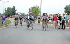  ?? LAURA BARTON/POSTMEDIA NEWS ?? Cyclists are greeted by cheers and high fives as the ride into Hunters Pointe in Welland on Saturday, wrapping up the seven-day Tour Du Lac ride around Lake Ontario to raise money for Wellspring Niagara.