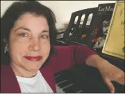  ?? (AP/Anne D’Innocenzio) ?? Associated Press retail writer Anne D’Innocenzio sits at her piano in her apartment in New York. Her piano has been a source of comfort during the coronaviru­s outbreak.