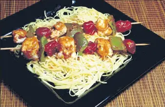  ?? LINDA GASSENHEIM­ER / TNS ?? Thai-inspired chicken kabobs served over noodles.