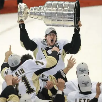  ?? Matt Freed/Post-Gazette ?? Penguins captain Sidney Crosby raises the Stanley Cup, June 12, 2009, at Joe Louis Arena in Detroit.