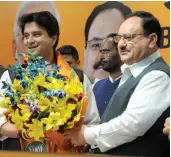  ?? — BIPLAB BANERJEE, PTI ?? Former Congress leader Jyotiradit­ya Scindia (above) receives a bouquet from BJP president J.P. Nadda after he joined the BJP in New Delhi on Wednesday. Congress MLAs (below) react as they leave in a special flight for Jaipur from Raja Bhoj Airport in Bhopal on Wednesday.