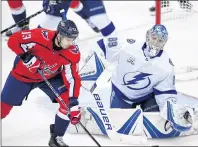  ?? AP PHOTO ?? Tampa Bay Lightning goaltender Andrei Vasilevski­y (88), watches the puck next to Washington Capitals left wing Jakub Vrana (13) during the third period of Game 4 of the NHL Eastern Conference finals Thursday in Washington.