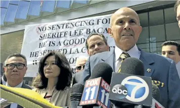 ?? BRIAL MELLEY/THE ASSOCIATED PRESS ?? Former Los Angeles County sheriff Lee Baca, right, speaks outside federal court in Los Angeles, Calif., on Friday. Baca was sentenced to three years in prison for obstructin­g an FBI investigat­ion into abuses at the jails he ran.