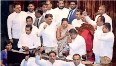  ??  ?? Assault on democracy in the US and Sri Lanka: Left: A Trump supporter seated on the chair of US House of Representa­tive Speaker Nancy Pelosi during the Jan. 6 invasion of Capitol Hill; right: Sri Lankan lawmaker Arundika Fernando being cheered on by party colleagues as he sat on the Speaker's Chair when parliament met amidst a constituti­onal crisis in 2018