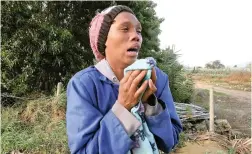  ?? PICTURE: IAN LANDSBERG ?? HEARTBROKE­N: Rehana Louw, a fellow farm dweller, broke down in tears when she saw the remains of the two-bedroom house on the guava farm Simonsvale where four people died on Wednesday.