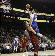 ?? MATT SLOCUM — THE ASSOCIATED PRESS ?? The Sixers’ Ben Simmons, right, fouling Cleveland’s Kevin Love in the first half Tuesday night, returned after a twogame absence with a shoulder injury. Simmons had 15 points and six assists in a 98-97Sixers win.