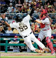  ?? AP/KEITH SRAKOKIC ?? St. Louis Cardinals catcher Yadier Molina was unable to get the tag in time on the Pittsburgh Pirates’ Josh Bell, but the Cardinals rallied in the ninth inning for a 4-3 victory Friday night.