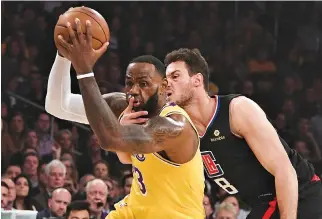  ?? RICHARD MACKSON-USA TODAY SPORTS ?? LOS ANGELES CLIPPERS forward Danilo Gallinari (8) fouls Los Angeles Lakers forward LeBron James (23) as James drives to the basket during the first quarter at Staples Center.