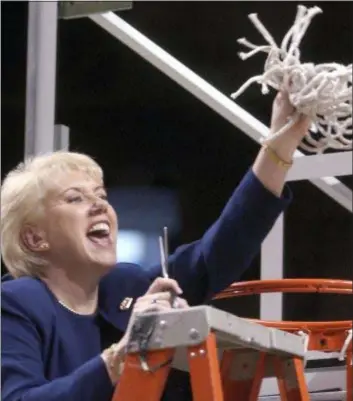  ??  ?? In this March 2, 2003 file photo Penn State women’s basketball coach Rene Portland waves the net she cut down to celebrate their Big 10 regular season championsh­ip after defeating Wisconsin in State College. Portland, a Broomall native who built the Nittany Lions into a women’s basketball powerhouse during a 27-year tenure, has died after a three-year fight with cancer. She was 65.