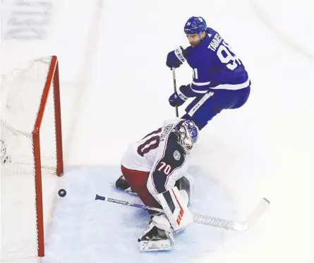  ?? ANDRE RINGUETTE / FREESTYLE PHOTO / GETTY IMAGES ?? John Tavares of the Toronto Maple Leafs finishes a breakaway by scoring on Joonas Korpisalo of the Columbus Blue Jackets in Game 2 of their Eastern Conference qualificat­ion round series Tuesday. The goal took put the Leafs up 2-0 en route to a 3-0 final.