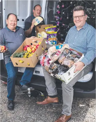  ?? Picture: Kevin Farmer ?? MORE ROOM TO MOVE: Unpacking the new delivery van are (from left) Greg Kowald, Tony Hurle and Andrew Bullen at Tony’s Community Kitchen.