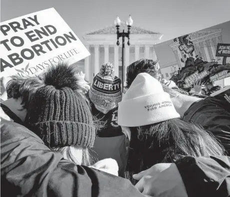  ?? ANDREW HARNIK/AP ?? Activists pray last week outside the Supreme Court during arguments in an abortion case.