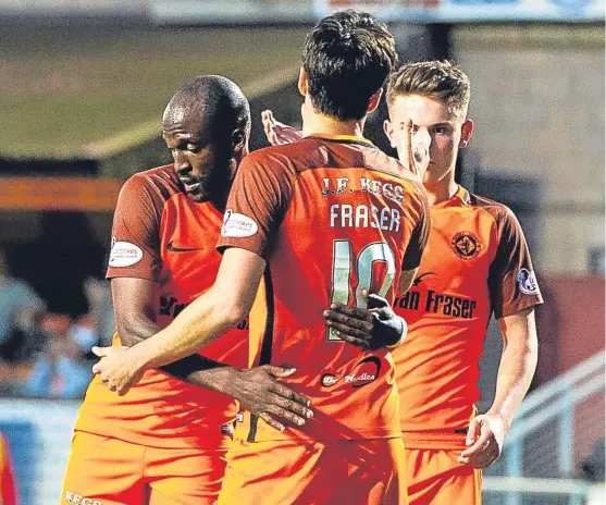  ?? Picture: SNS Group. ?? Patrick N’Koyi, left, celebrates the first of his two goals with Scott Fraser after the midfielder set him up.