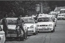  ?? Juan Barreto / AFP/Getty Images ?? Drivers line up to buy fuel last week in San Antonio, Tachira state, Venezuela, which is on the border with Colombia.