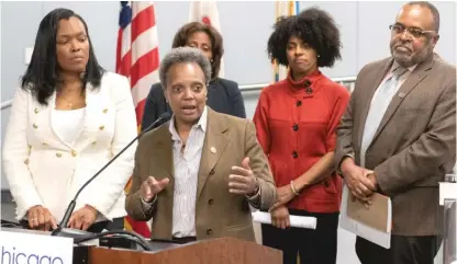  ?? TYLER LARIVIERE/SUN-TIMES ?? Mayor Lori Lightfoot and education officials answer reporters’ questions ahead of statewide school closures due to COVID-19 on Monday.