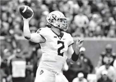  ?? Associated Press ?? Oklahoma State quarterbac­k Mason Rudolph (2) attempts a pass during the first half of an NCAA college football game against West Virginia on Saturday in Morgantown, W.Va. Oklahoma State defeated West Virginia, 50-39.