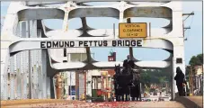  ?? Tribune News Service ?? The body of Rep. John Lewis pauses at the top of the bridge for one minute while making the final crossing over the Edmund Pettus Bridge on July 26, 2020 in Selma, Ala.