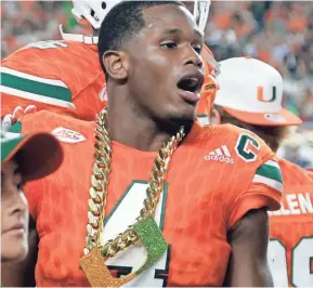  ??  ?? Miami defensive back Jaquan Johnson wears the turnover chain after intercepti­ng a pass against Notre Dame on Nov. 11.