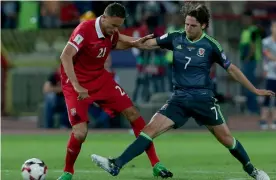  ?? — AP ?? Wales’ Joe Allen (right) and Nemanja Matic of Serbia vie for the ball on Sunday.