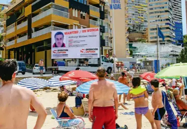  ??  ?? Anthony Dennis’s face is displayed on a digital advertisin­g van to curious onlookers on a Spanish beach