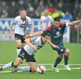  ??  ?? Jamie McGrath, Dundalk is brought down in the penalty area by John Russell, Sligo but play is waved on by the referee. Picture: Ken Finegan.
