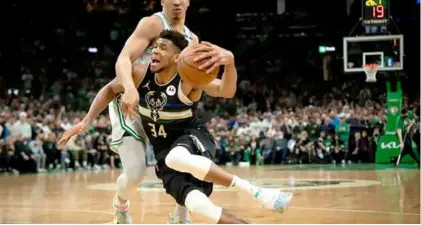  ?? AFP/VNA Photo ?? CLOSE CALL: Milwaukee's Giannis Antetokoun­mpo is fouled by Grant Williams of Boston in the Bucks' 110-107 victory over the Celtics in game five of their NBA playoff series.