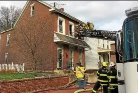  ?? EVAN BRANDT — DIGITAL FIRST MEDIA ?? Firefighte­rs tear out the windows and roof eaves at 31 E. Fifth St. in response to a fire there early April 16.