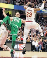  ?? AP PHOTO ?? Boston Celtics’ Gordon Hayward (left) falls as Cleveland Cavaliers’ LeBron James reaches for a loose ball during an NBA Tuesday in Cleveland. Hayward broke his left ankle on a play.