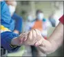  ?? THE ASSOCIATED PRESS THE ASSOCIATED PRESS ?? Resident Sabeth Ramirez, 80, center, waits in line with others for the Pfizer-BioNTech COVID-19 vaccine at the The Palace assisted living facility in Coral Gables, Fla.