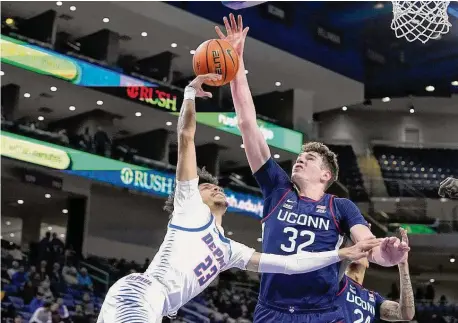  ?? Charles Rex Arbogast/Associated Press ?? UConn's Donovan Clingan (32) blocks the shot of DePaul's Caleb Murphy on Jan. 31 in Chicago.