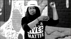  ?? Screenshot taken from "Unspeakabl­e" ?? Venita Smith uses American Sign Language to represent the word “power” in a Black Lives Matter PSA created by local artist and cinematogr­apher Emmai Alaquiva.