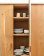  ??  ?? ABOVE Quaint holes in the freestandi­ng pantry/ crockery cupboard provide ventilatio­n and act as a visual tool to break up the French oak panels. BELOW Display shelving intersects a splashback of understate­d subway tiles, while open cabinetry and stainless-steel surfaces reflect the home’s industrial aesthetic. OPPOSITE Baker stools by IMO sit at the island beneath a trio of pendants from Melbourne’s Fat Shack Vintage. Kilim rugs soften the concrete floor.