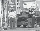  ?? TAMMY LJUNGBLAD/ KANSAS CITY STAR VIA AP ?? Police work the scene of shooting at a bar in Kansas City, Kansas.