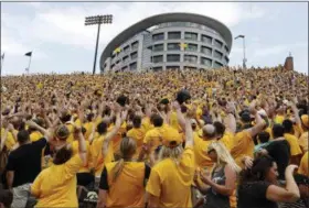  ?? THE ASSOCIATED PRESS FILE ?? Iowa fans wave towards fans watching from University of Iowa’s children’s hospital at the end of the first quarter. In the new tradition, known as The Wave, fans turn to wave to the pediatric patients watching from the hospital.