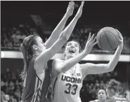  ?? AP/JESSICA HILL ?? Connecticu­t guard Katie Lou Samuelson (right) set an American Athletic Conference single-game tournament scoring record with 40 points in Monday night’s 100-44 victory over South Florida.